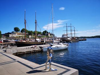 Sailboats moored in harbor