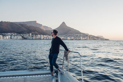 Full length of man on sea against clear sky