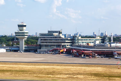 View of factory at airport against sky