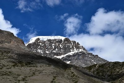 Low angle view of snowcapped mountain against sky