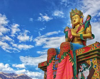 Low angle view of statue against temple against sky