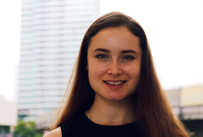 Portrait of smiling woman in city