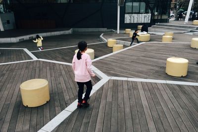 Full length of woman standing by railing