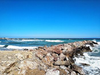 Scenic view of sea against clear blue sky