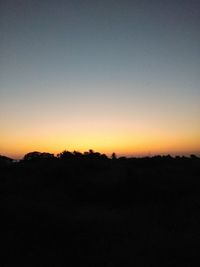 Scenic view of silhouette landscape against clear sky at sunset