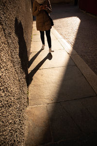 Low section of woman walking on street