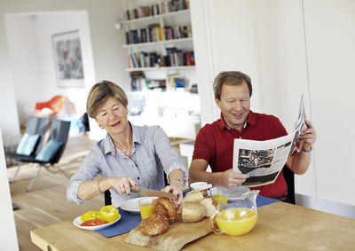 Mature couple eating breakfast at table