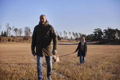 Couple walking with dog