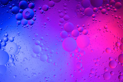 Close-up of water drops against blue background