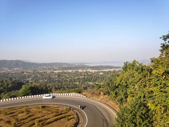 High angle view of road amidst landscape against clear sky