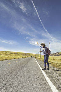 Man standing on road against sky
