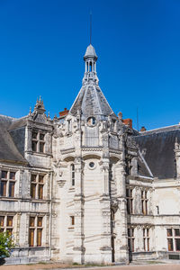 Low angle view of historic building against clear blue sky