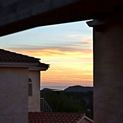 Built structure against cloudy sky at sunset