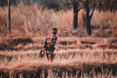 Rear view of man standing on field