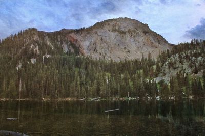 Scenic view of lake against cloudy sky