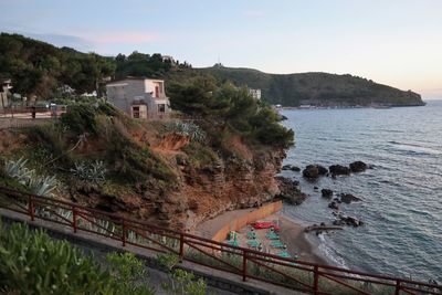 High angle view of buildings by sea against sky