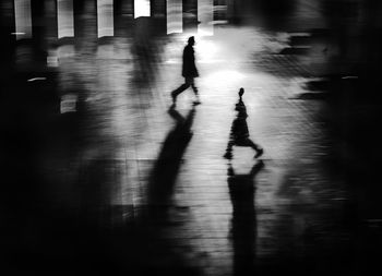 High angle view of silhouette people walking on street