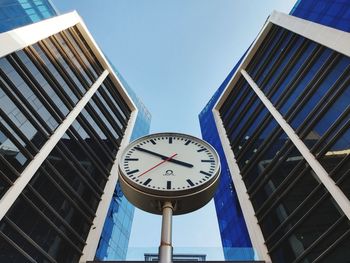 Low angle view of clock tower against blue sky