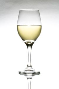 Close-up of wineglass against white background