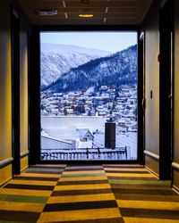 Scenic view of snowcapped mountains seen through window