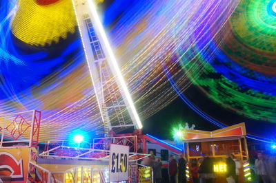 Low angle view of light trails at night