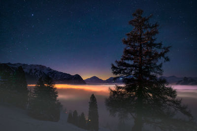 Scenic view of lake against sky at night