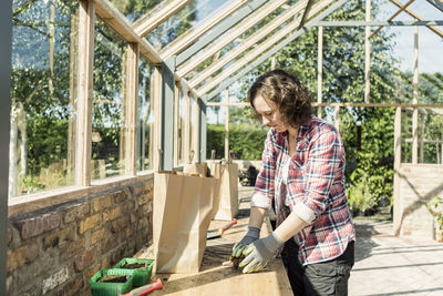 Mature woman working in greenhouse