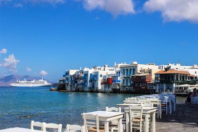 Boats in harbor against buildings in city