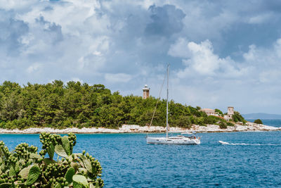 Sailboat in sea against sky