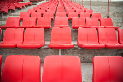 Red empty chairs in row at stadium