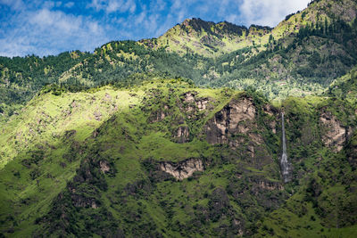 View of rocky landscape against mountain range