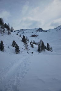 Scenic view of snow covered mountains against sky