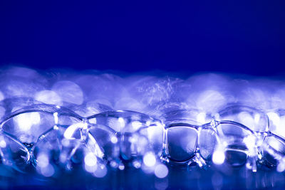 Close-up of water drops against blue background