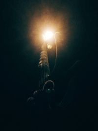 Low angle view of illuminated street light at night