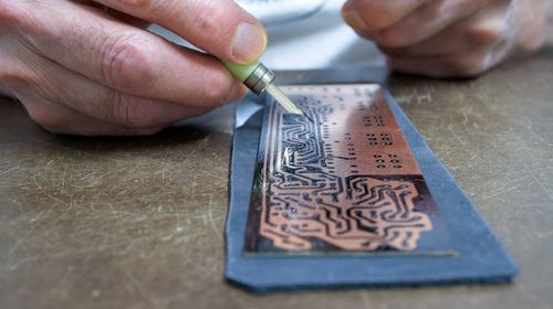 Cropped hand of person working on table