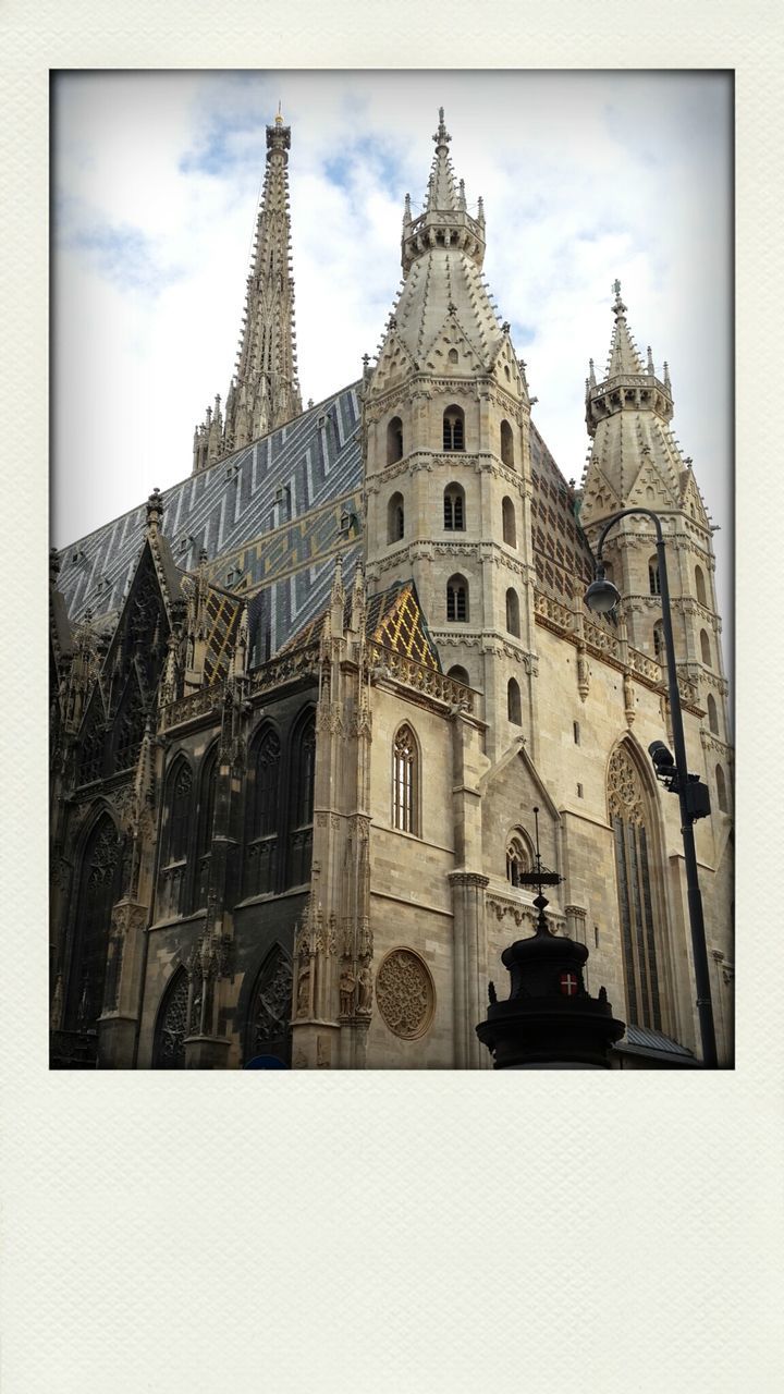 transfer print, building exterior, place of worship, architecture, religion, church, built structure, spirituality, cathedral, low angle view, sky, auto post production filter, history, famous place, travel destinations, dome, cloud - sky, cross