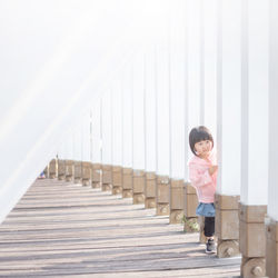 Full length of woman standing by railing