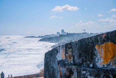 Scenic view of sea against buildings during winter