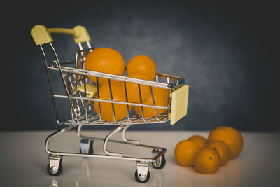 Close-up of orange fruits in basket on table