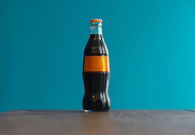 Close-up of drink on table against blue background