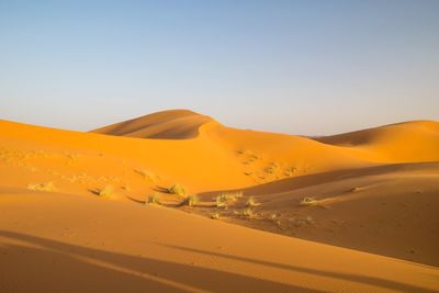 Scenic view of desert against clear sky