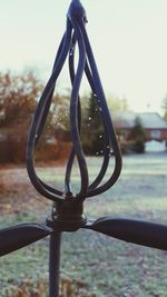 Close-up of metal against sky