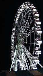 Low angle view of ferris wheel against sky at night