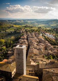 High angle view of buildings in old town against cloudy sky