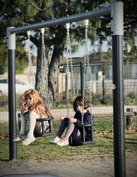 Portrait of smiling young woman sitting in park