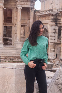 Young woman standing at historical building