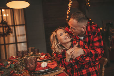 Candid authentic happy married couple spends time alone at lodge xmas decorated