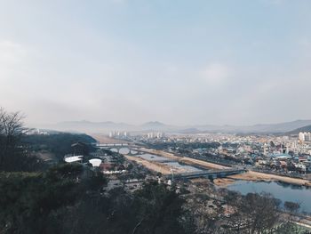 Aerial view of cityscape against sky