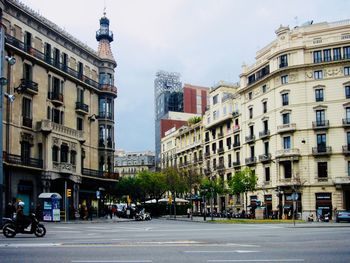 City street by buildings against sky