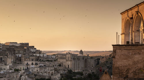 Buildings in city at sunset